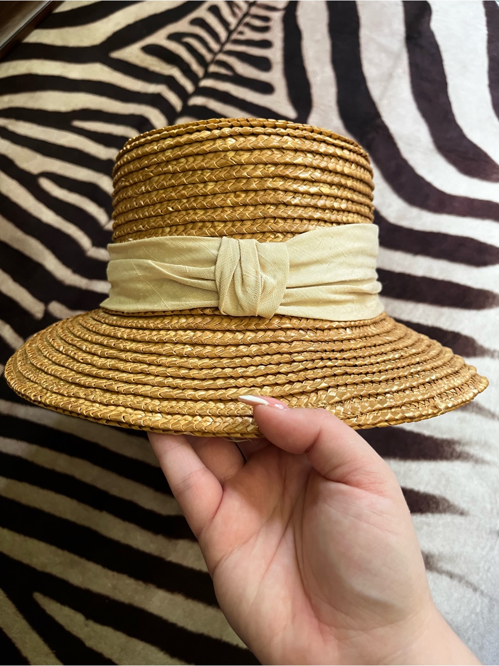 Straw Sun Hat With Cream Bow Trim.